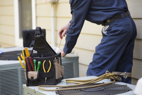 Technician services outside AC units.